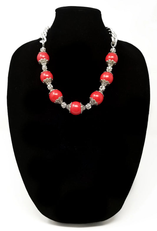 red magnesite gemstone and crystal statement necklace with argentium silver chain for women shown on necklace display